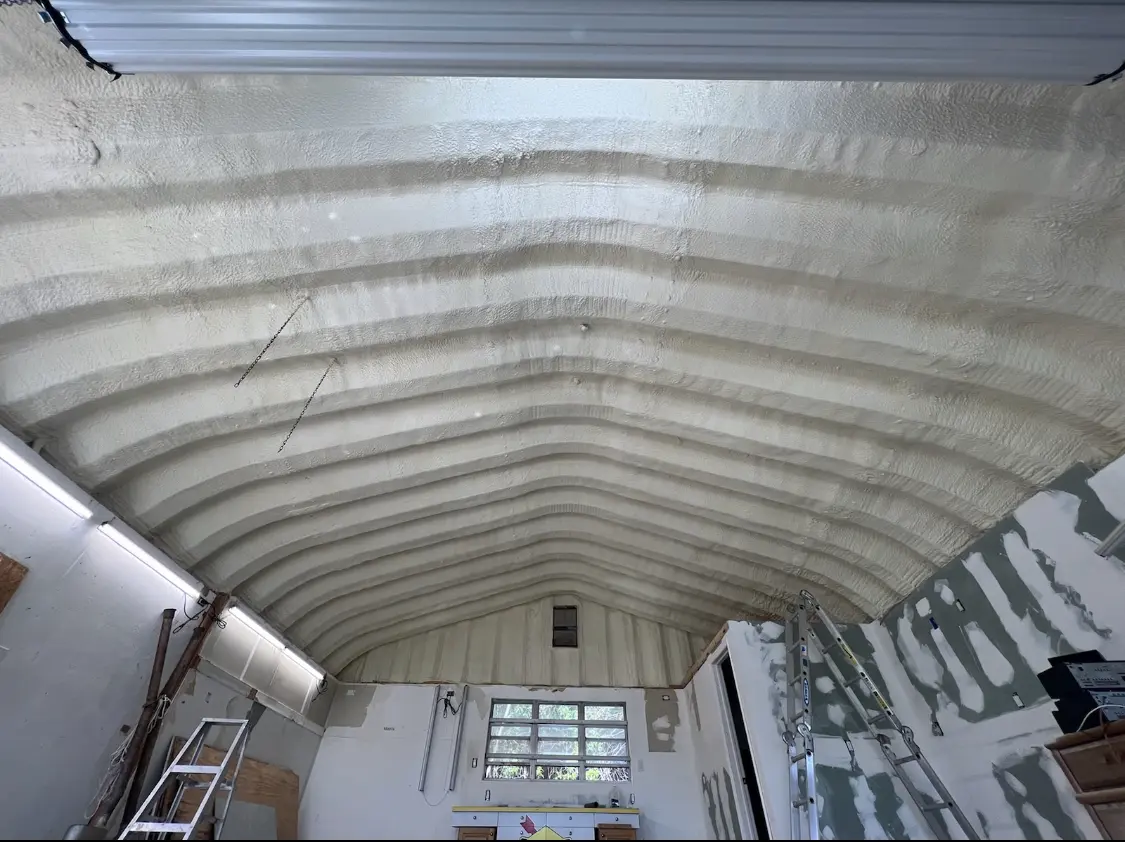 Spray polyurethane foam applied to the underside of a metal roof deck in Sherwood